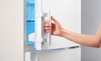 Woman opening refrigerator